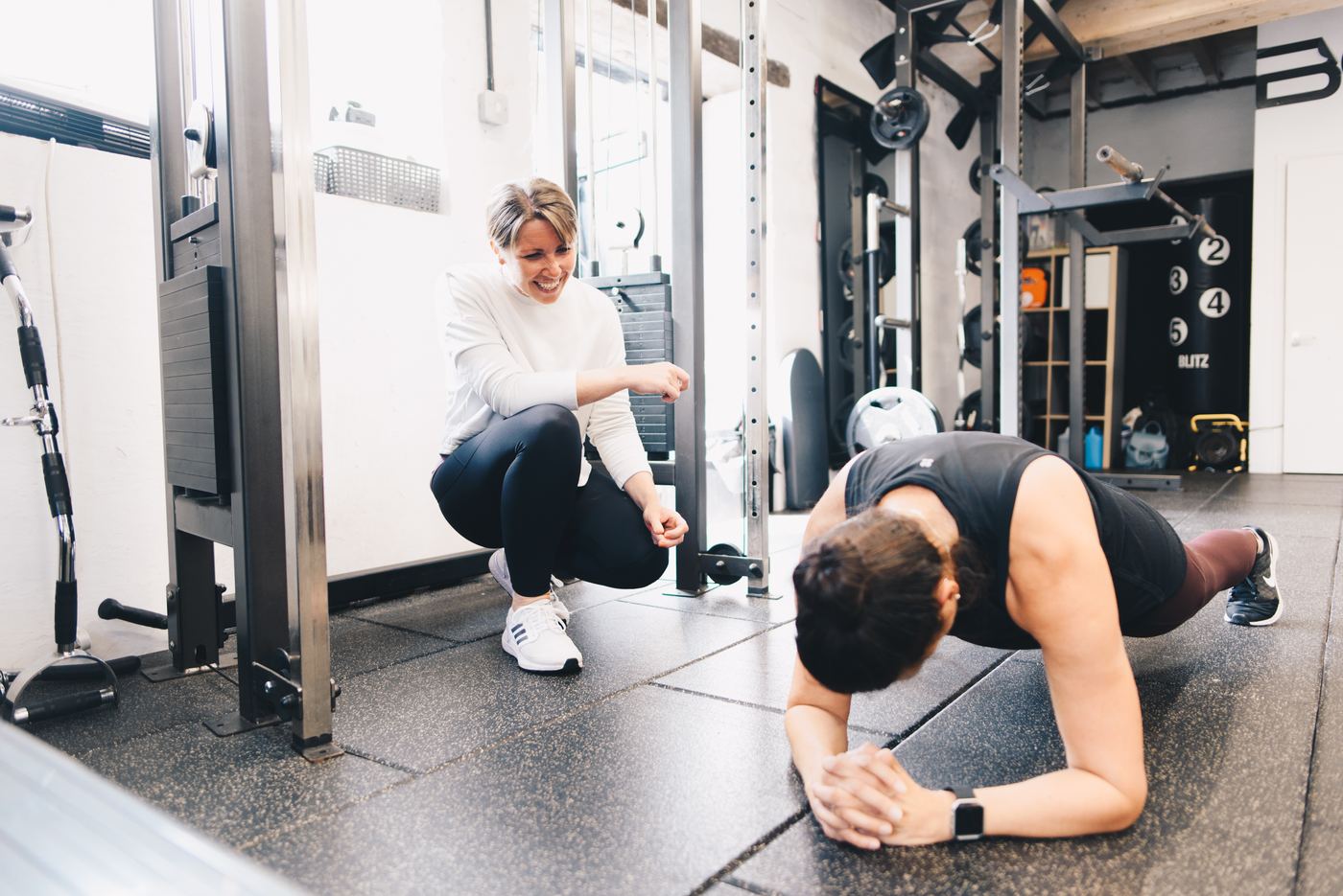Pam coaching a client through a plank
