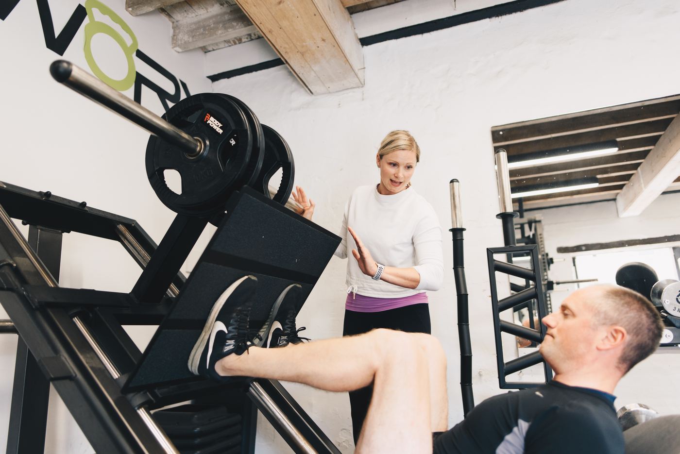 Jo coaching a leg press