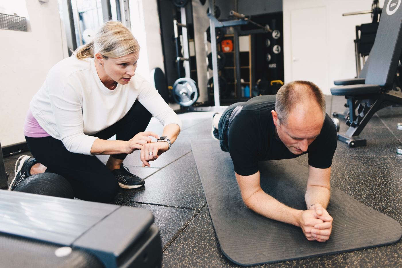 Jo helping a client hold a plank